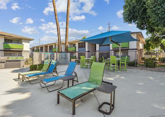 our apartments have a patio with chairs and umbrellas